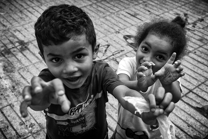 A young boy and girl playing for the camera in a Moroccan medina