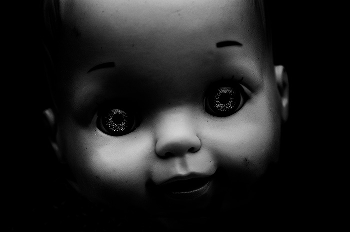 Close up portrait of a doll's face with prominent eyes