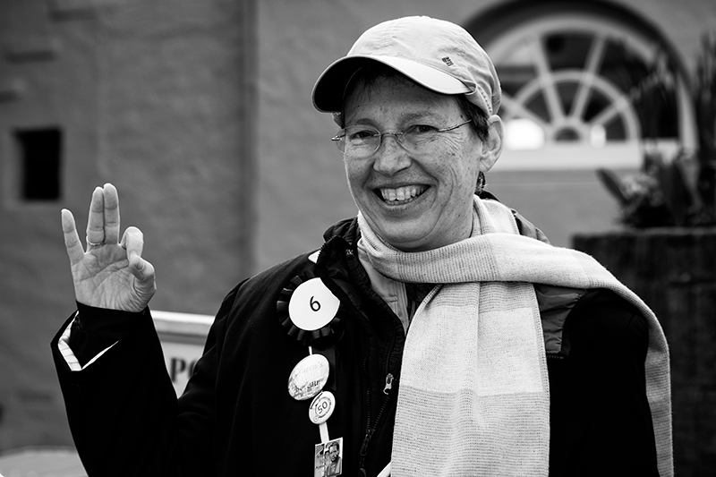 Woman giving the 'be seeing you' hand sign