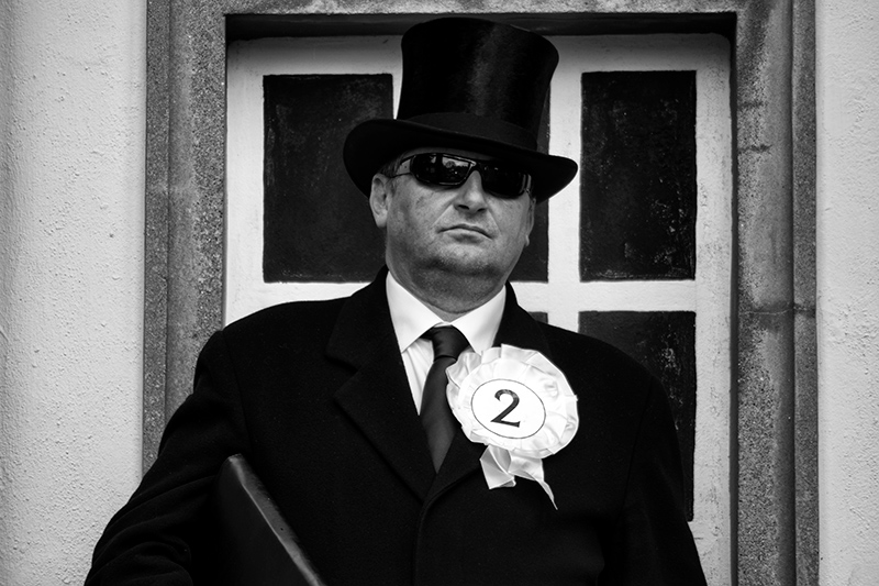 Portrait of the undertaker wearing a No.2 rosette