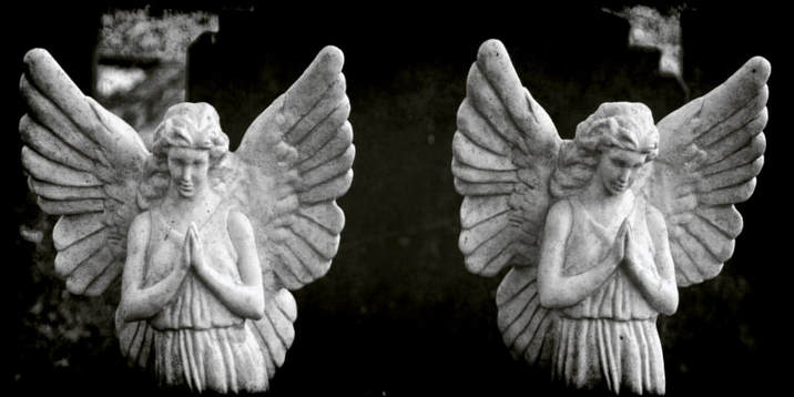 cym0231bw10x5 Graveyard Statues of two praying angels standing alongside each other