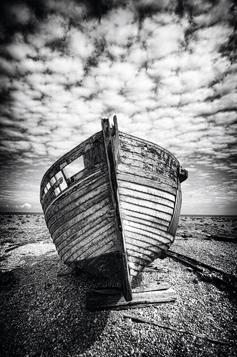 eng0053bw10x15pnewcom_orig The bow of a decaying fishing boat under a mackerel sky at Dungeness