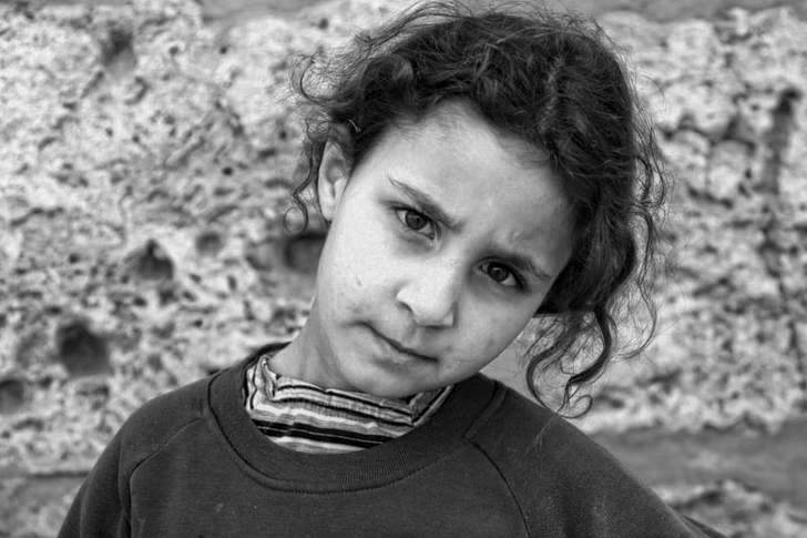A young girl in Tunisia poses for a photograph in exchange for a few dirhams