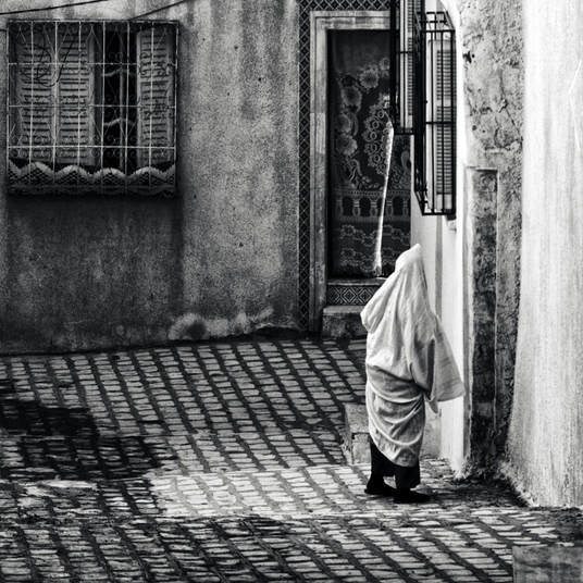 Woman in hijab facing away from the camera in the medina in the Tunisian city of Sfax